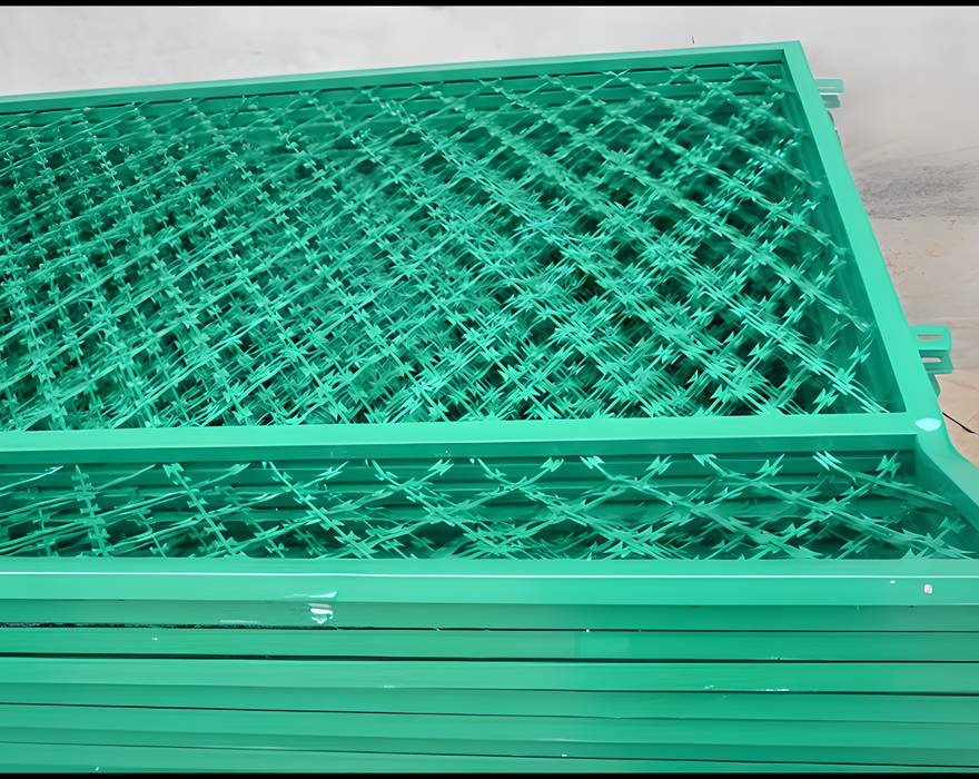 Several pieces of green color PVC coating welded razor wire mesh on the ground.