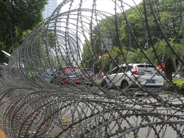 Mobile security barriers are installed on the left side of road to guide traffic.