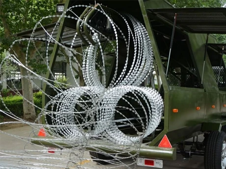 A vehicle extending a mobile security barrier down